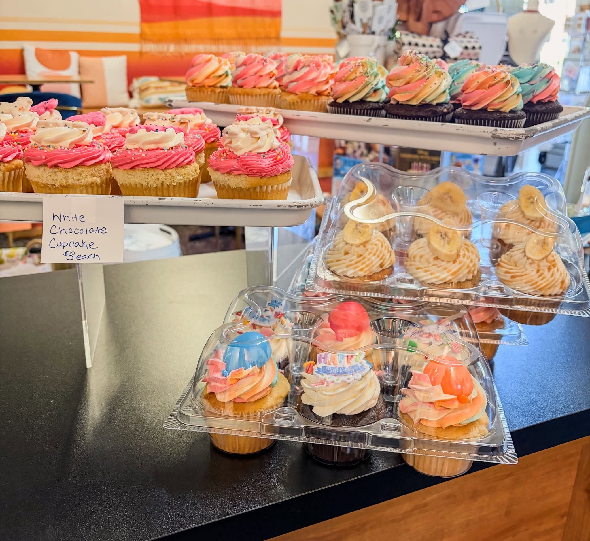 Colorful frosted cupcakes displayed at Sugarmill Sweets